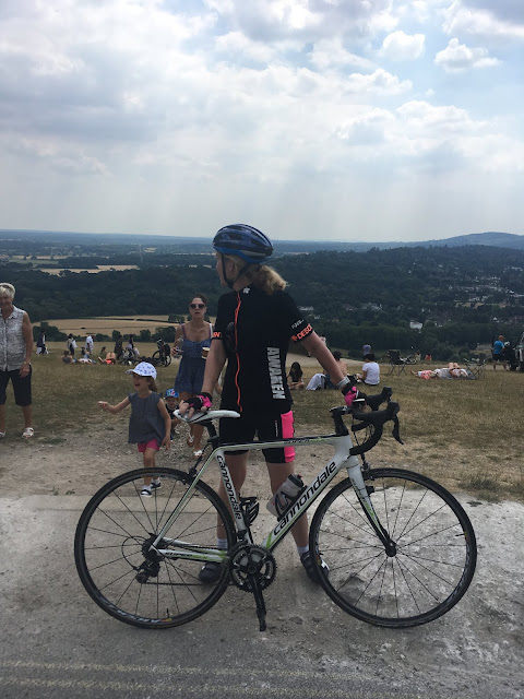 steph posing with her bike at the top of Box Hill in Surrey