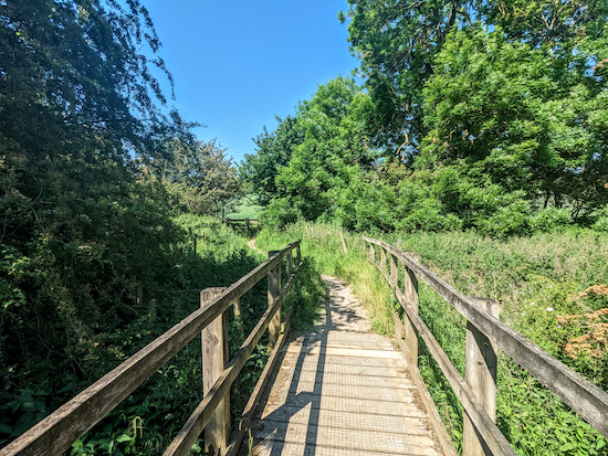 Cross the footbridge then head uphill on Essendon Footpath 13