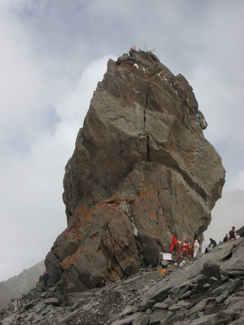 Shrikhand Mahadev Trekking : A wonderful journey through clouds (25th - 30th July 2008): Posted by VJ SHARMA on www.travellingcamera.com :Shrikhand Mahadev Trek (It was a trekking for us)Shrikhand Mahadev is situated at an height of 18,700 ft. above sea level in the Great Himalayan National Park of Himachal Pradesh, India. Trek for Shrikhand mahadev starts from Jaon village in Nirmand region of Kullu district (Himachal Pradesh)RAMPUR-NIRMAND:Satluj river view from roadside between Rampur & Nirmand.JAON VILLAGE: Jaon village is in Nirmand region of Kullu District from where this trekking starts. Don't expect that you can buy few things from this place. So its better to buy the important/useful stuff from Shimla. If you haven't contacted any adventure club for planning this trek for you, then give it a second thought at this place. You can hire a coolie here who can also help you to complete this trek in better way. (Ask for a person called Dhola Ram who can help you for the same)Broken down mud-house on the way to Shrikhand MahadevThere were three dogs in this house to take care of an apple orchid near Jaon village.Small rickety bridge over mountain stream on way to Shrikhand Mahadev (Near Jaon Village)Solitary apple hanging from tree on way to Shrikhand Mahadev. There are lot of apple orchids between Jaon village and Singh Ghat.SINGH-GHATShrikhand river flowing near Singh GhatBarahati:A bubbly and frothing mountain stream on way to Shrikhand Mahadev (Near Barahati)Thacharu : Singh-Ghat to Thacharu is steep stretchA pitched tent on way to Shrikhand Mahadev (Thachru)Valley of Flowers:Beautiful view of Clouds moving around mountains on the way to Shrikhand Mahadev (Near Valley of Flowers)Beautiful view of mountains and clouds from Valley of Flowers on trek to Shrikhand MahadevMountain in shadow on way to Shrikhand Mahadev. You can also see full moon in this pic. This is early morning. Most of the pictures here are shot between 6:00 am & 8:00am. After that it becomes very difficult to see things due to clouds. But its a great feeling to walk through clouds...Shadow of one mountain on top of another on way to Shrikhand MahadevKaali Ghati: This is a hill top, where we reach by crossing 4 hills after Thachru. All are 75 degree steep hills.View of Shrikhand Mahadev from Kaali Ghati: Shrikhand shivalingam can be clearly seen from Kaali ghati before 7:30 am. After that clouds cover the whole area and visibility radius reduces to 15 meters.Bheem Dwari: Bheem Dwari is a beautiful valley on the way to Shrikhand Mahadev. It surrounded by lot of waterfalls from hills covered with snow.Wonderful waterfall view from Bheem Dwari..A small part of longest waterfall in Shrikhand Mahadev Trek...Parvati Bag: Parvati Bag is a place where you see grass last time durin the trek to Shrikhand, the final destination. After this place Rock hills starts with clouds at ground level. So we were literally in clouds after Parvati Bag.Clouds, and sunlight over a mountain on trek to Shrikhand Mahadev (This is morning view from Parvati Bag, when we started third say trek for our final destination: Shrikhand Mahadev)Pitched tent on way to Shrikhand Mahadev (We spent two nights in Parvati Bag)Sunlight coming through hill top : Wonderful view from Kali ghatiSun light crossing though hills...Nain SarovarMountain shadow convering Nain sarovar on the way to Shrikhand Mahadev...DHOLA RAM JI Porter enjoying a cigarette break on way to Shrikhand MahadevCloud Store @ Bheem Paudi (Strains to heaven)Fellow trekkers climbing rock hills between Nain Sarovar and Shrikhand MahadevGlaciers between Nain Sarovar and Shrikhand Mahadev...Rock-made shivalingam on the great heights of mountains. The shivalingam is 72 feet high and stands still at the mountain top, above 18,000 ft altitude.SHRIKHAND MAHADEV TREKKING: Rock-made shivalingam on the great heights of mountains. The shivalingam is 72 feet high and stands still at the mountain top, above 18,000 ft altitude.