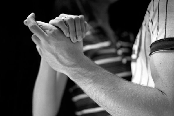 Un hombre baila con su pareja con los dedos cruzados.