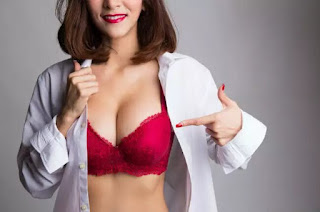 Girl wearing a red Demi or Half cup bra under shirt creating overflowing breasts deep cleavage