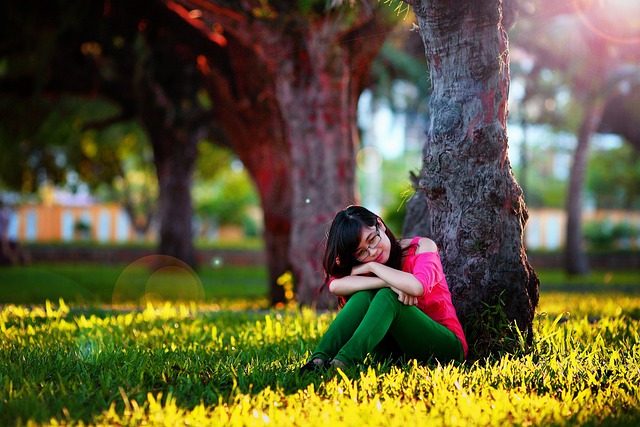 A very cute girl with pink top sitting under the tree in the park- sad girl dp