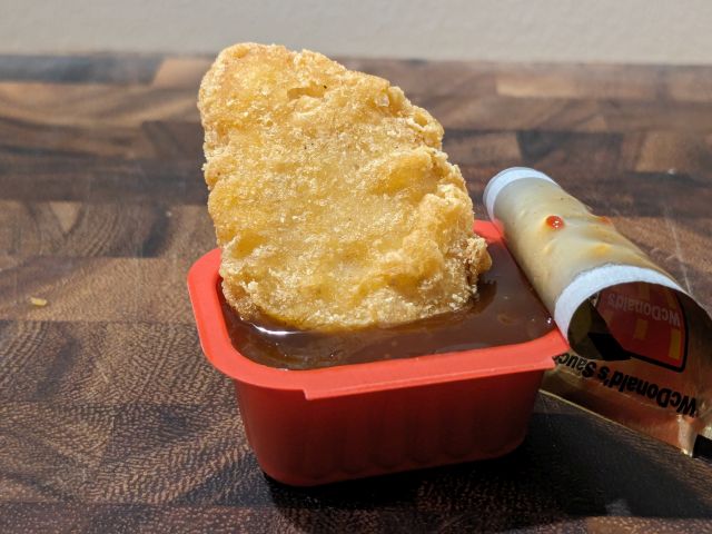 A Chicken McNugget dipped in McDonald's WcDonald's Sauce.