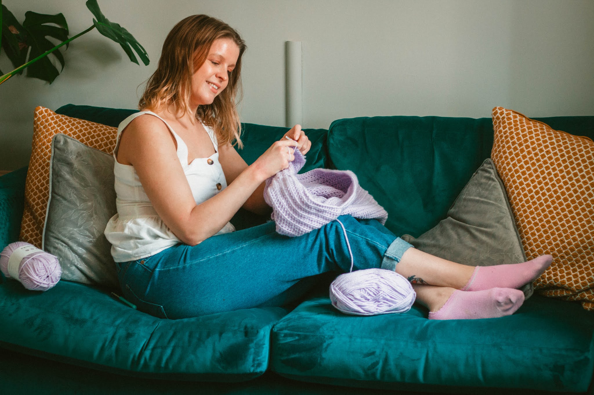 girl crocheting lilac jumper - 5 creative hobbies for self care blog post