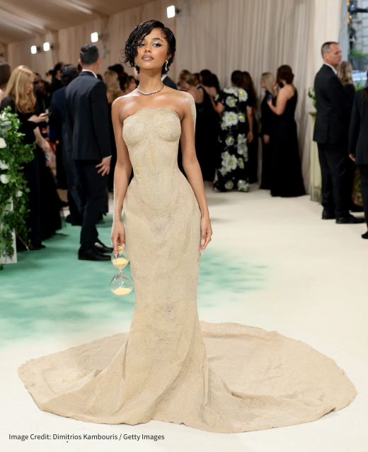 Photo of Tyla at the 2024 Met Gala. She is wearing Balmian - a floor length, skin-tight dress that resmbles sand.