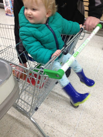 toddler in shopping trolley wearing his wonderful wellies