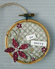 Embroidery hoop Christmas decoration with poinsettia in traditional colours 