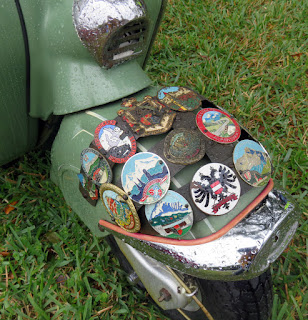 Regional metal tags affixed to front fender.