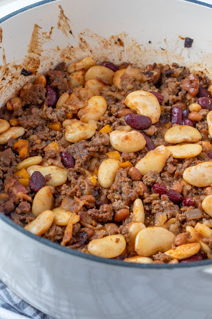 These Calico Beans are made with ground beef, bacon, bell pepper and three kinds of beans. It is the ultimate comfort food dinner main dish or side dish! Perfect for summer BBQ's or Sunday dinner in the winter time!