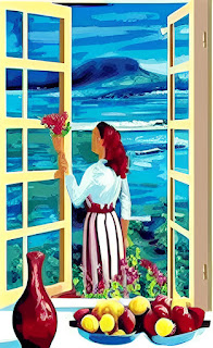 woman in a garden outside open windows facing the ocean