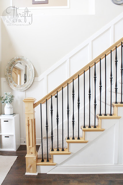 two story entry way with board and batten staircase and walls. Knotty alder and wrought iron banister.