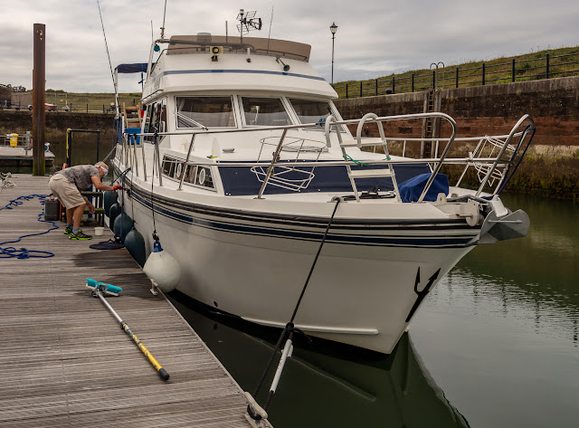 Photo of Ravensdale moored up the wrong way around while Phil cleans her starboard side