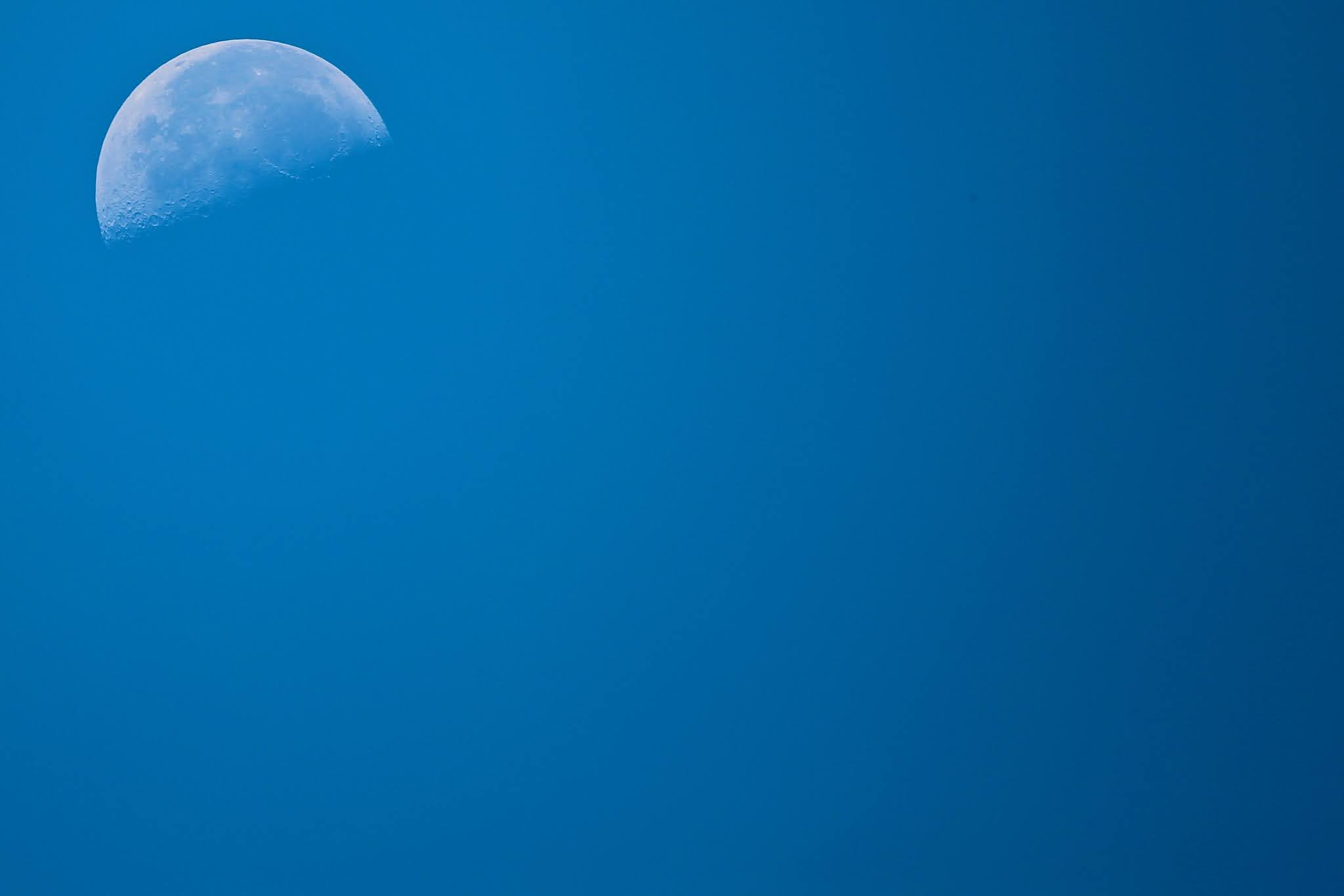 Moon in the clear blue sky background for presentations, high resolution free