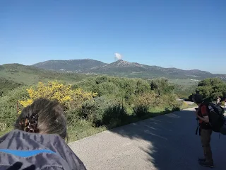 Murielle's head, a road, in the background a pointy mountain with a cloud on top