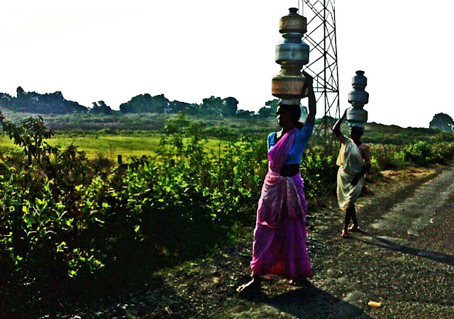 women carrying pots of water on head