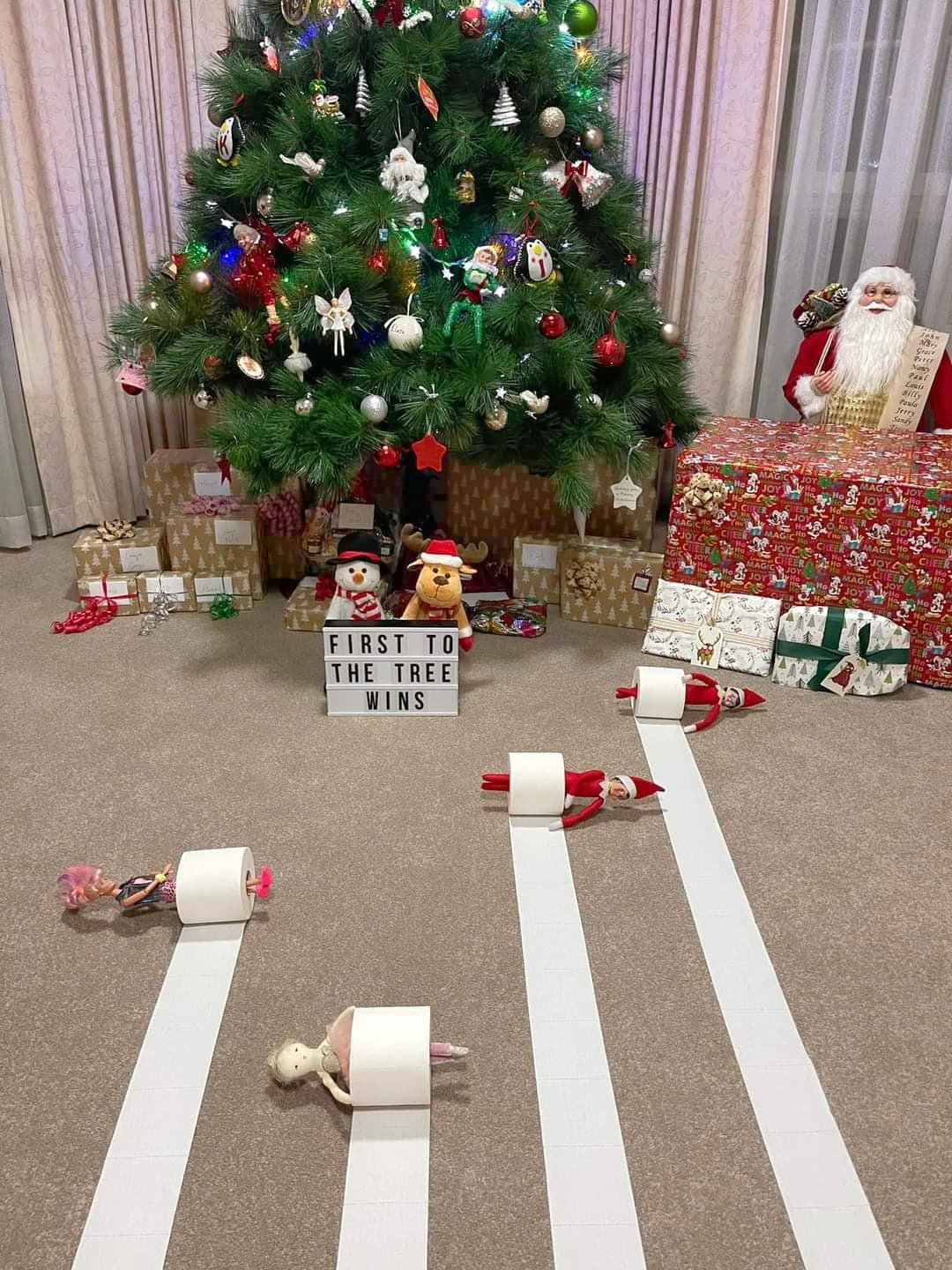 elf and other toys having a race in toilet paper rolls