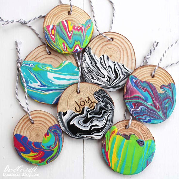 Marbled Wood Slice Ornaments with Plaid Crafts!  Marbling is the most amazing craft and it's easy!  These show-stopping wood slice ornaments take just 15-20 minutes, minus the drying time.  Plaid makes it easy with their awesome line of Marbling Paints.  Plaid Marbling Paints are mixed and ready to pour. They don't blend together, so all the individual colors stay bright and vivid.
