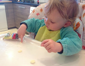 picture of a toddler poking a white chocolate button