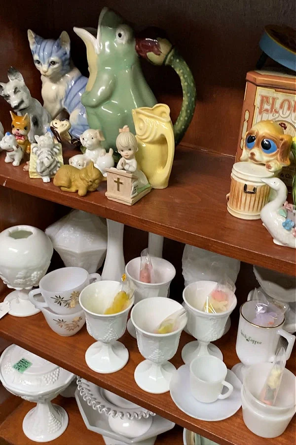 Frog Pitcher and Animal Figurines on thrift store shelves