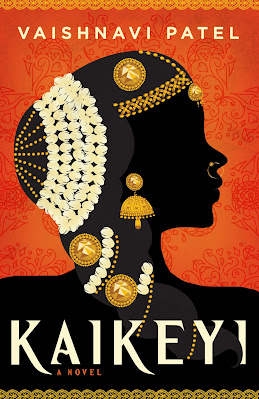 Silhouette of a woman's head against an orange background. Her hair is covered with gold baubles and white beads.