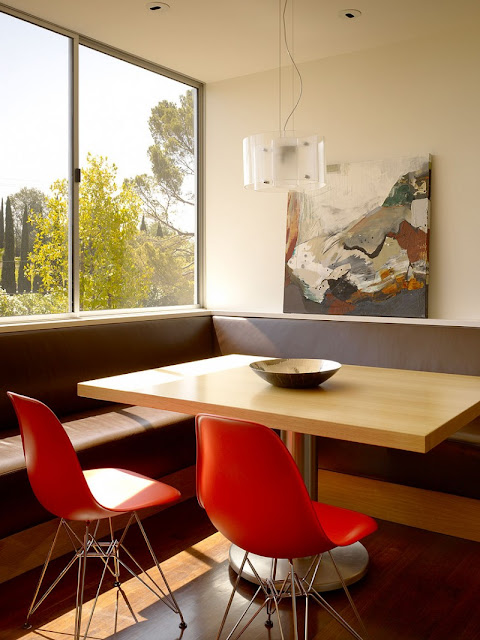 Red Chairs in Home Breakfast Space with Wooden Table and Sectional Brown Wooden Bench