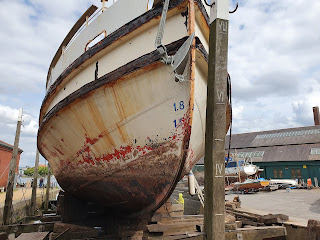 Photo of an old boat in dry dock for repairs