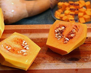 Cut the bulb in half (How to Safely Cut a Butternut Squash into Pretty Little Cubes, Step by Step ♥ AVeggieVenture.com)