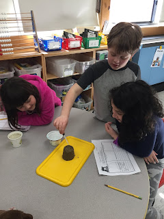 Picture three of students doing an erosion experiment