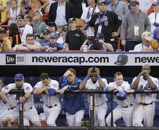 The New York Mets line the dugout steps during their 4-2 loss to the Florida Marlins in their final game of the season at Shea Stadium in New York on Sunday, Sept. 28, 2008. (AP Photo/Julie Jacobson)
