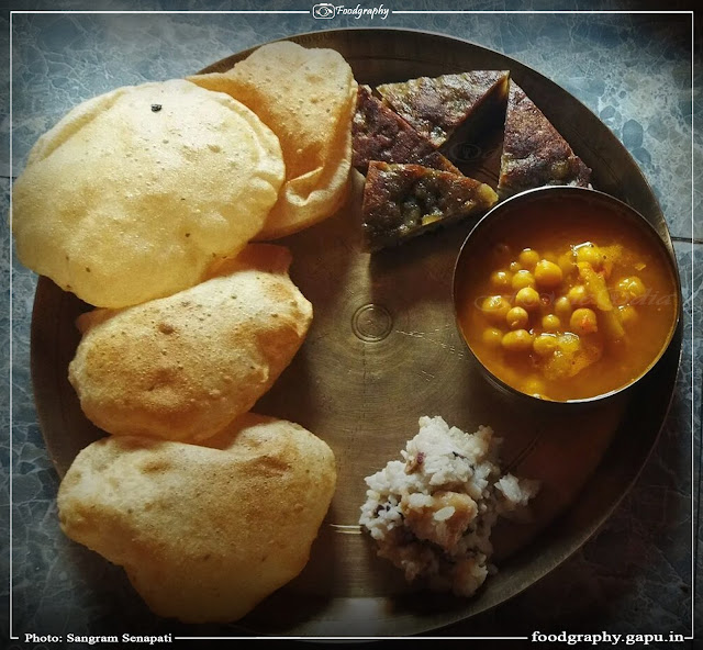 Delicious Puri, Ghuguni, Poda Pitha and Makar Chaula for breakfast on the day of Makara Sankranti