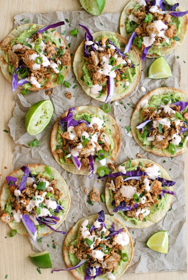 Tuna Tostadas with Chipotle Crema are full of bold flavor, made by topping crisp baked tortillas with seasoned tuna, creamy avocado, fresh red cabbage, and a spicy chipotle crema.