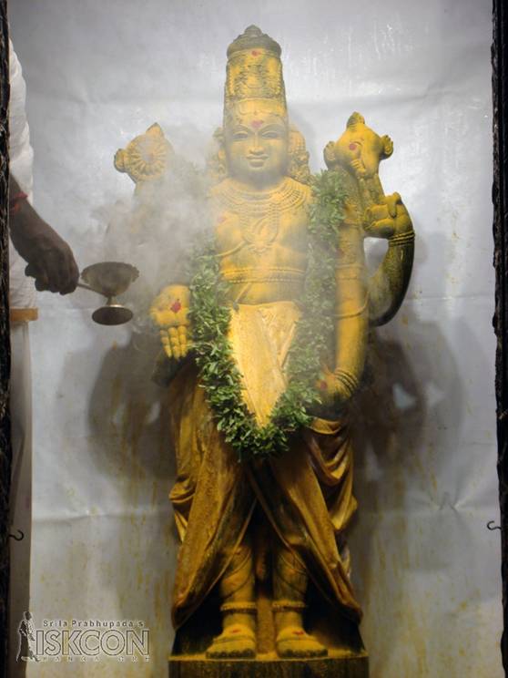 Applying Turmeric Powder to Lord Balaji
