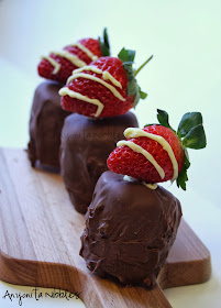 Nutella mousse on a cheesecake-style biscuit base, covered in strawberry  chocolate and topped with a strawberry