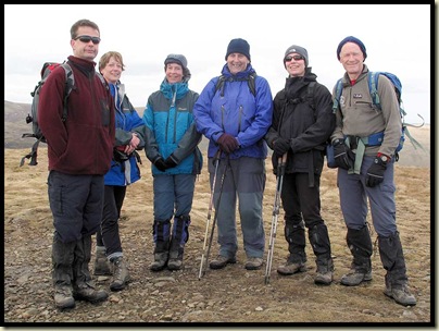 A mottley crew huddle on the spiky 1658 metre summit