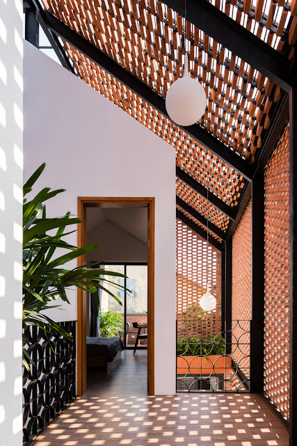 vestibule hallway with spaced bricks to create playful light patterns, milk glass globe light