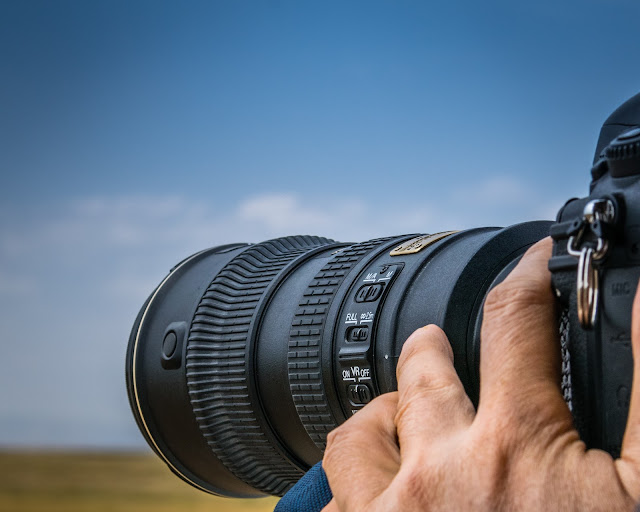 Person with a SRL camera with a lens taking a picture