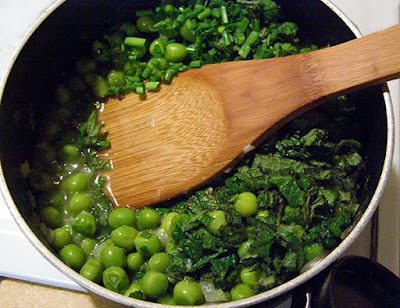 Saucepan of Cooked Peas with Herbs on Top