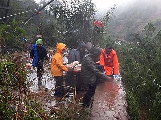 Rescuers transport the body of a landslide victim from the mountainous village of Irisan in Baguio City at the height of typhoon 'Pepeng.'