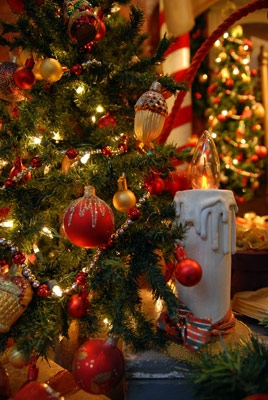 close up photo of decorated Christmas tree and white candle