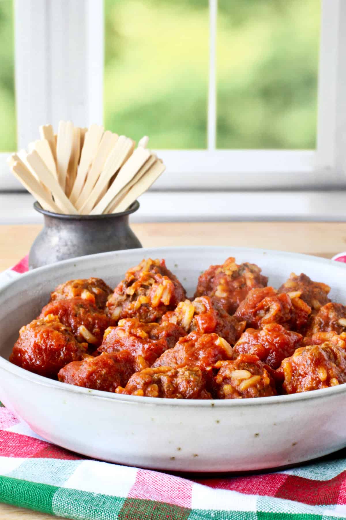 Porcupine Meatballs with tomato sauce in bowl.