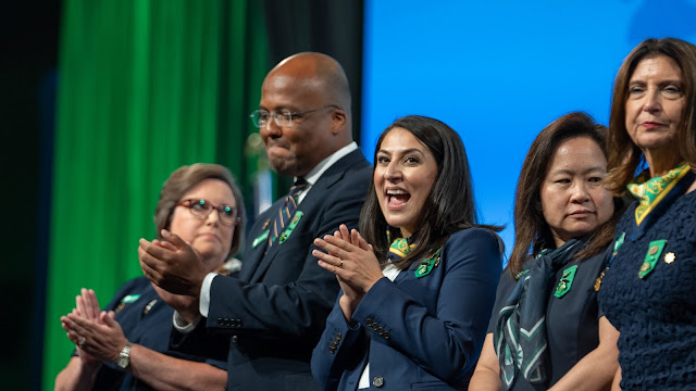 Girl Scout National Board Officers Mary Ann Altergott, Trooper Sanders, Noorain Khan, Jeanne Kwong Bickford, and Diane Tipton applaud and smile on stage