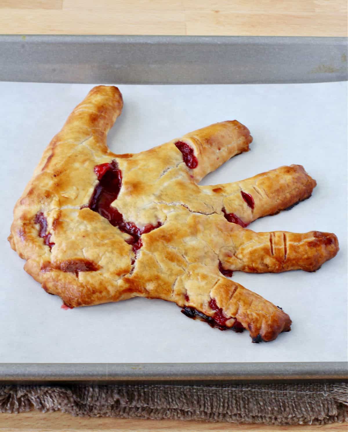 Severed Hand Pie on a baking sheet.