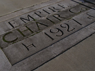 concrete sign for Empire Chair Company