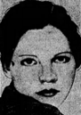 A glamorous headshot of a beautiful young woman with short, dark hair looking over her shoulder into the camera with her large, wide-set eyes