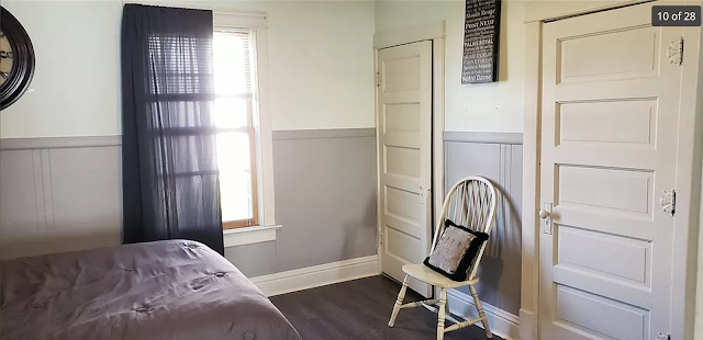 color photo of bedroom of Sears No 112 showing two painted doors with Sears Stratford hardware and Sears hinge