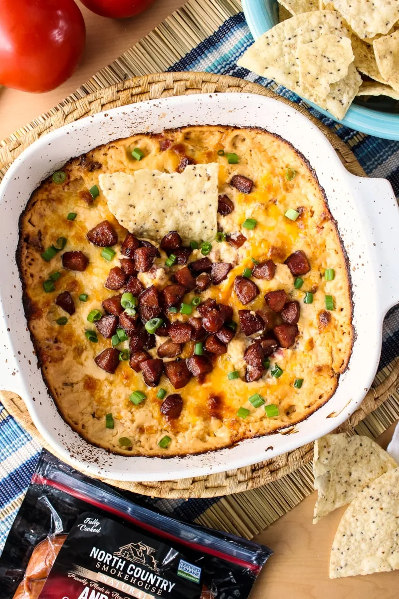 Cheesy Baked Andouille Dip is not your average sausage dip. It is creamy, super cheesy, easy to make, and full of bold Cajun flavor that will knock your socks off!  #northcountrysmokehouse #certifiedhumane #organic #superbowl #ad