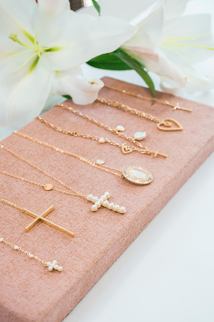 Gold necklaces laid on display on a necklace display platform.