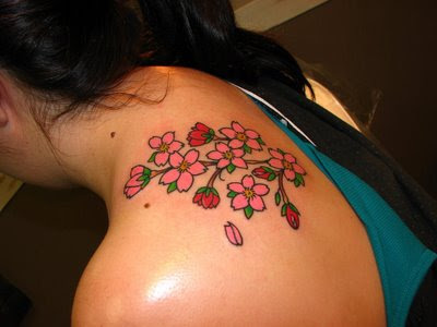 back shoulder tattoos. small flower tattoo on wrist.