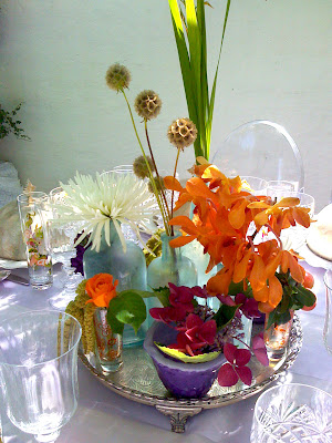 The centerpiece is a simple and elegant arrangement of vintage bottles