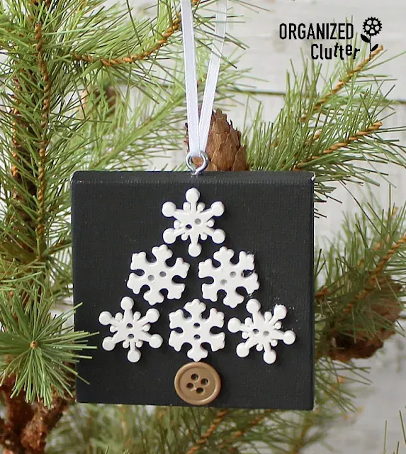 Photo of a snowflake button tree on a black mini canvas.